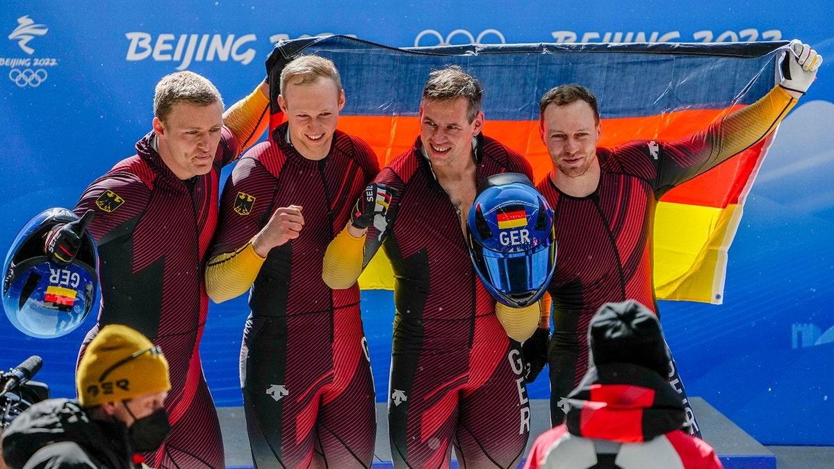 Francesco Friedrich, Thorsten Margis, Candy Bauer and Alexander Schueller, of Germany, celebrate winning the gold medal in the 4-man at the 2022 Winter Olympics, Sunday, Feb. 20, 2022, in the Yanqing district of Beijing.