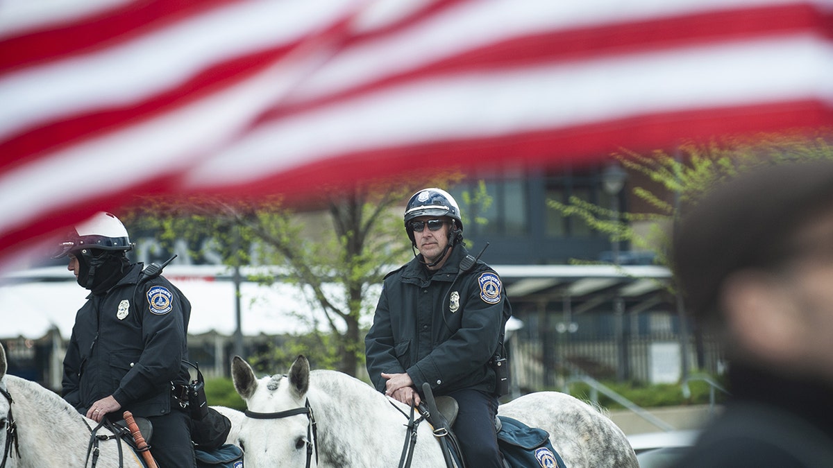Police officers on horseback guard a protest outside the National Rifle Association Institute for Legislative Action (NRA-ILA) Leadership Forum in Indianapolis, Indiana, U.S., on Friday, April 26, 2019.  Photographer: Matthew Hatcher/Bloomberg via Getty Images