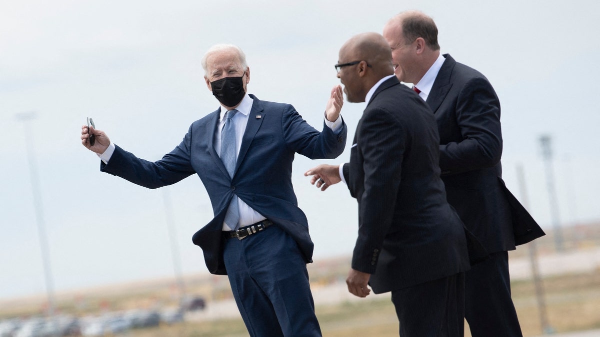 Denver Mayor Michael Hancock (C) and Colorado Governor Jared Polis (R) greet US President Joe Biden as he arrives at Denver International Airport September 14, 2021, in Denver, Colorado. (Photo by BRENDAN SMIALOWSKI/AFP via Getty Images)