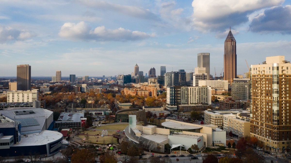 The Bank of America Plaza tower, right, above the World of Coca Cola, the Atlanta Aquarium, and the National Center for Civil and Human Rights tourist attractions in Atlanta, Georgia, U.S., on Saturday, Dec. 4, 2021. Residents of the Atlanta area are experiencing the worst inflation among major U.S. cities, with October prices up 7.9% from a year ago -- more than double the rate in San Francisco. Photographer: Elijah Nouvelage/Bloomberg