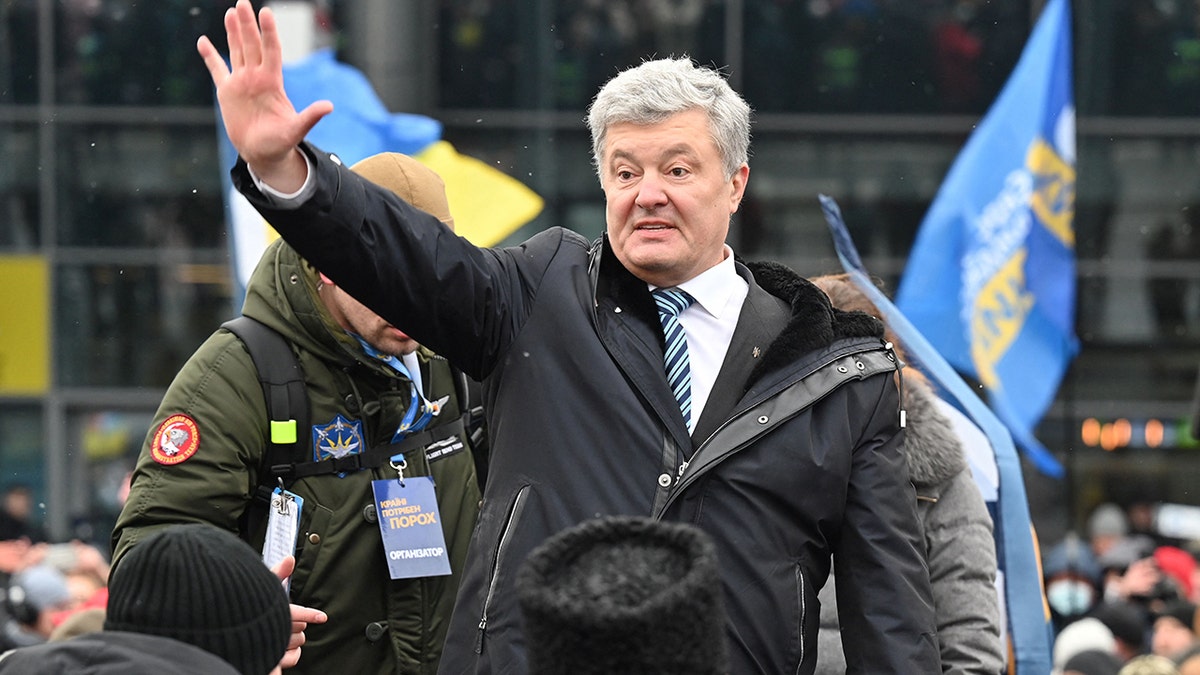 Ukraine's former leader Petro Poroshenko waves during a rally outside the airport upon his arrival in Kyiv on Jan. 17, 2022.