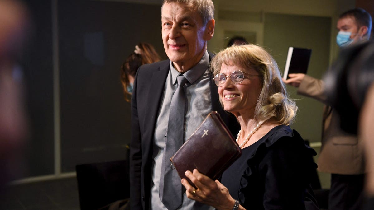 MP of the Finland's Christian Democrats Paivi Rasanen (R) holds a bible as she arrives with her husband Niilo Rasanen to attend a court session at the Helsinki District Court in Helsinki, Finland on January 24, 2022. - The trial against former interior minister and Christian Democrats leader Paivi Rasanen over four charges of incitement against a minority group has started on January 24, 2022. - Finland OUT (Photo by Antti Aimo-Koivisto / Lehtikuva / AFP) / Finland OUT (Photo by ANTTI AIMO-KOIVISTO/Lehtikuva/AFP via Getty Images)