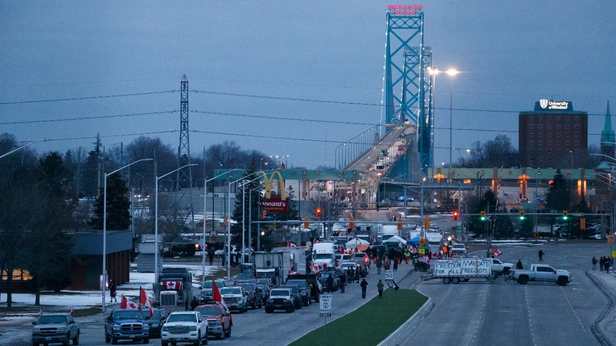 WINDSOR, ON - February 10: Protestors and supporters at a blockade at the foot of the Ambassador Bridge, sealing off the flow of commercial traffic over the bridge into Canada from Detroit, on February 10, 2022 in Windsor, Canada. As a convoy of truckers and supporters continues to occupy OttawaÕs downtown, blockades and convoys have popped up around the country in support of the protest against CanadaÕs COVID-19 vaccine mandate for cross-border truckers. (Photo by Cole Burston/Getty Images)