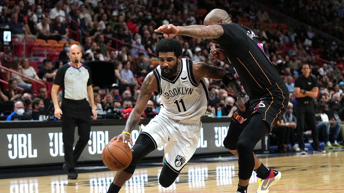 Kyrie Irving dribbles against the Heat