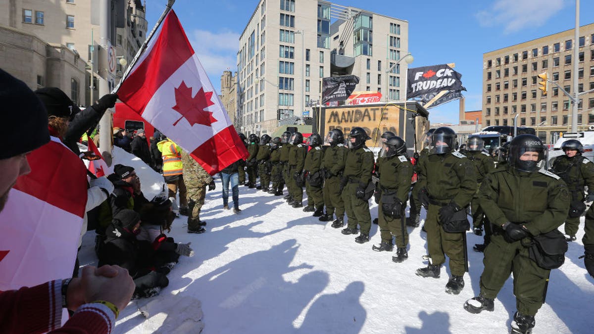 Ottawa Police move a line of protesters from the intersection at Sussex and Rideau Streets in Ottawa, Ontario, on Feb. 18, 2022.