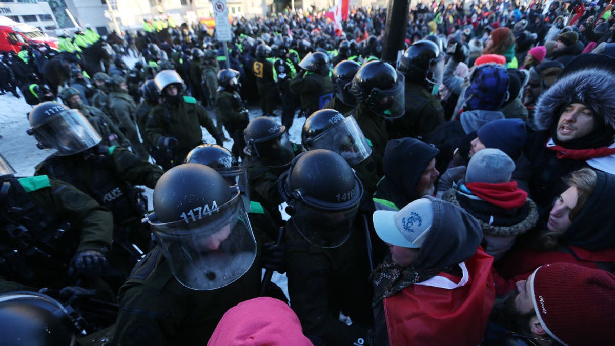 Police clash with convoy protesters in Ottawa, Ontario, on Feb. 18, 2022.