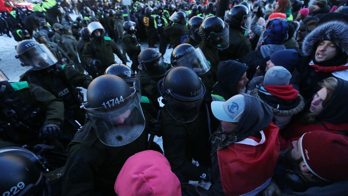 Police clash with convoy protesters in Ottawa, Ontario, on Feb. 18, 2022.