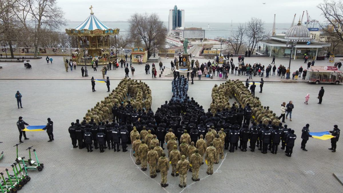 Some 450 cadets of the Odessa State University of Internal Affairs, the Military Academy of Odessa and the Institute of the Naval Forces of Ukraine form the coat of arms of Ukraine to show unity in Odessa, southern Ukraine, on Feb. 19, 2022. 