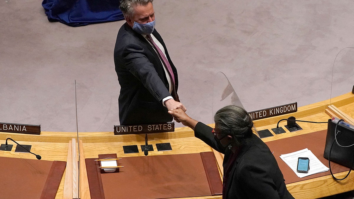 Permanent Representative of Ukraine to the United Nations Sergiy Kyslytsya (L) fist bumps U.S. ambassador to the UN Linda Thomas-Greenfield (R) after he spoke during an emergency meeting of the UN Security Council on the Ukraine crisis, in New York, Feb. 21, 2022. 