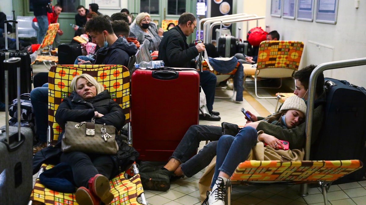 Passengers rest on camp beds in a temporary shelter inside a building of the railway station after arriving on a train from Kiev in Ukraine to Przemysl, Poland on February 25, 2022. Russian invasion on Ukraine can cause a mass exodus of refugees to Poland. (Photo by Beata Zawrzel/NurPhoto via Getty Images)