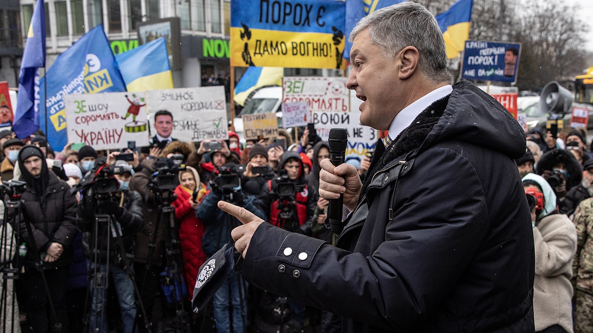 Ukraine's former President Petro Poroshenko speaks to supporters and media outside the Kyiv District Court of Appeal on Jan. 28, 2022.