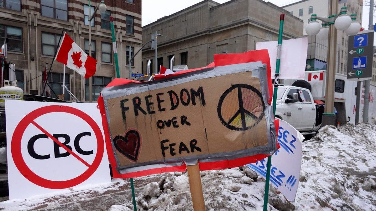OTTAWA, ONTARIO - FEBRUARY 16: Signs of support are planted in a snow bank near the parliament building where trucks have formed a blockade of streets as a demonstration led by truck drivers protesting vaccine mandates continues on February 16, 2022 in Ottawa, Ontario, Canada Prime Minister Justin Trudeau has invoked the Emergencies Act for the first time in Canada's history to try to put an end to the blockade which is now in it's third week. (Photo by Scott Olson/Getty Images)