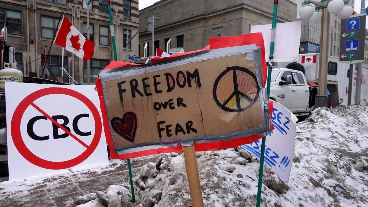 OTTAWA, ONTARIO - FEBRUARY 16: Signs of support are planted in a snow bank near the parliament building where trucks have formed a blockade of streets as a demonstration led by truck drivers protesting vaccine mandates continues on February 16, 2022 in Ottawa, Ontario, Canada Prime Minister Justin Trudeau has invoked the Emergencies Act for the first time in Canada's history to try to put an end to the blockade which is now in it's third week. (Photo by Scott Olson/Getty Images)