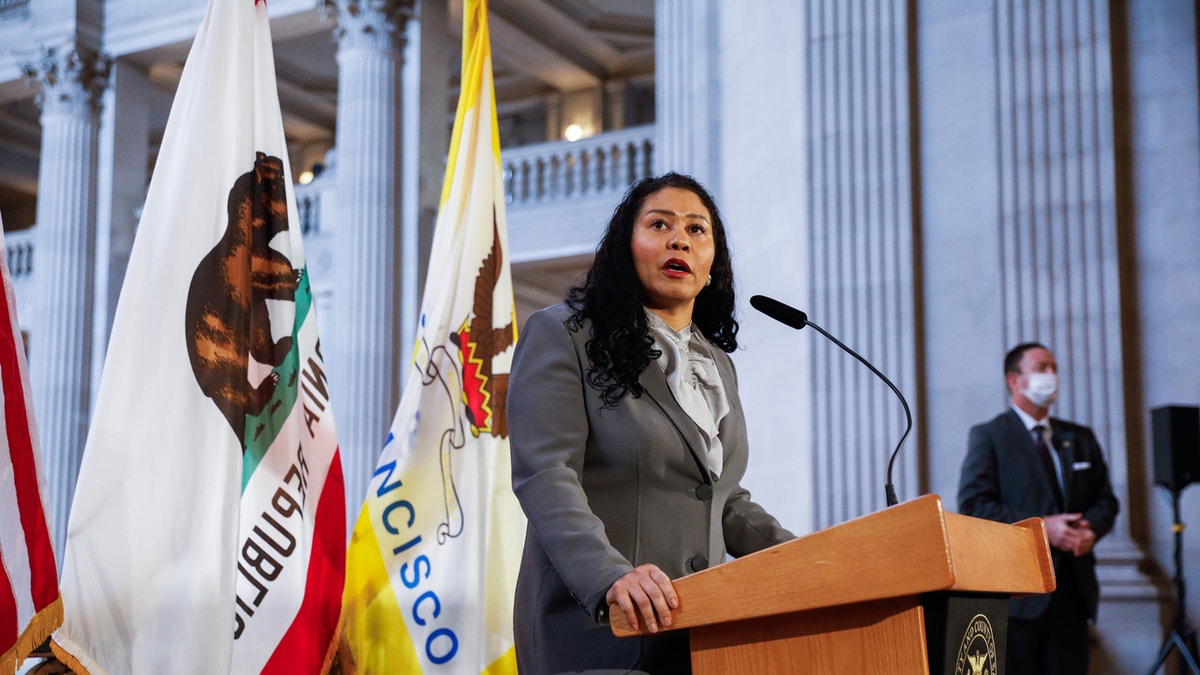 San Francisco Mayor London Breed stands at podium during press conference