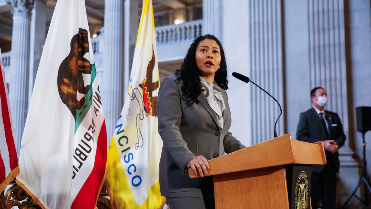 San Francisco Mayor London Breed stands at podium during press conference