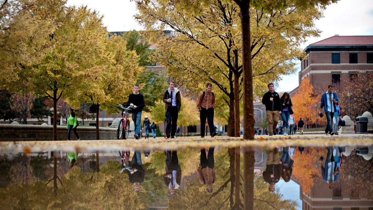 Students walk on the Purdue Mall on the campus of Purdue University in West Lafayette, Indiana, U.S., on Monday, Oct. 22, 2012. Photographer: Daniel Acker