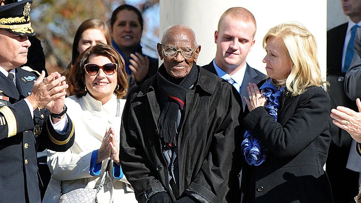 Richard Overton is acknowledged by former President Barack Obama during a ceremony to honor veterans at the Tomb of the Unknowns on Veterans Day at Arlington National Cemetery on November 11, 2013, in Arlington, Virginia.