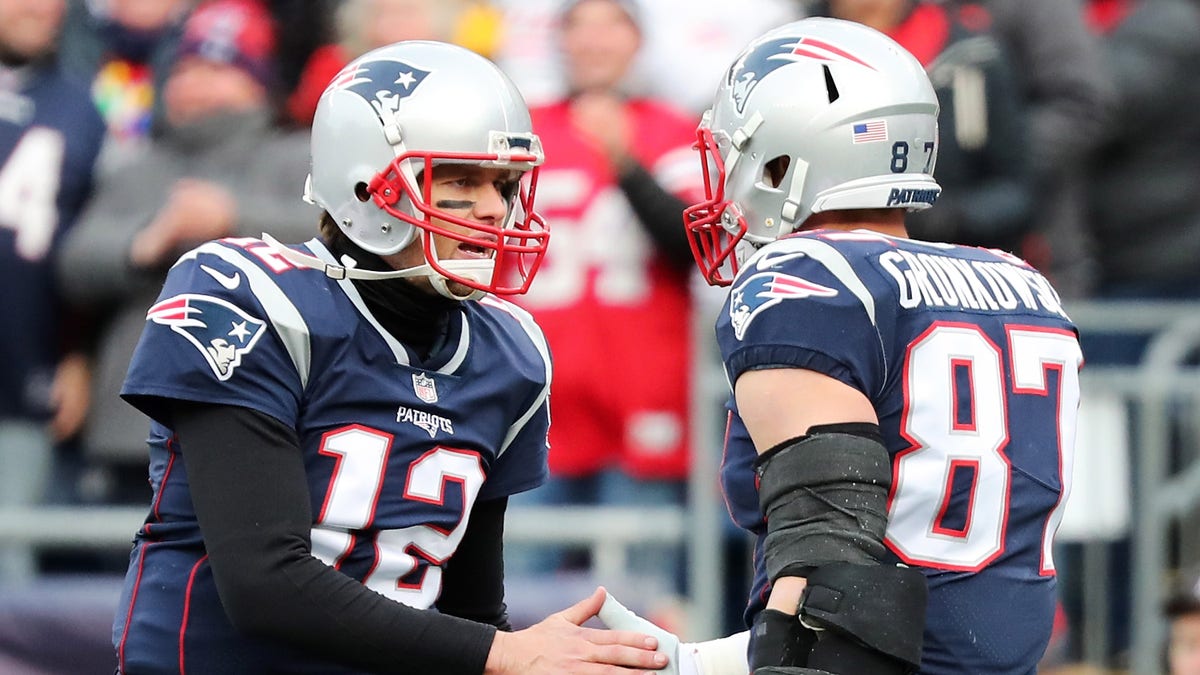 Rob Gronkowski (87) of the New England Patriots reacts with Tom Brady (12) after catching a touchdown pass during the second quarter of a game against the Buffalo Bills at Gillette Stadium on Dec. 24, 2017, in Foxboro, Massachusetts.