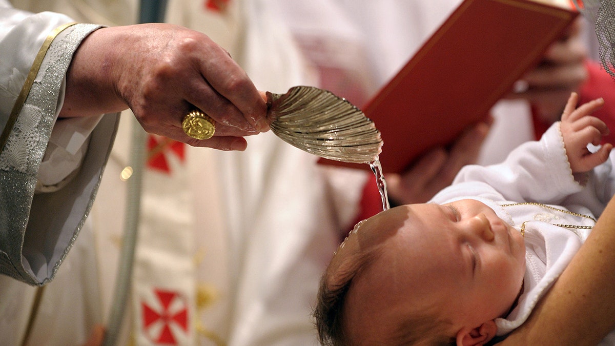 Pope Benedict XVI baptizes a newborn baby in Michelangelo's Sistine Chapel on Jan. 10, 2010, in Vatican City, Vatican. 