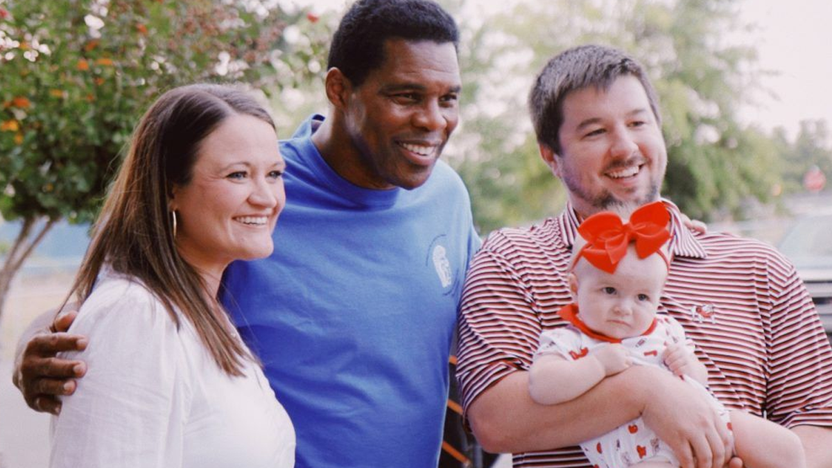 Herschel Walker poses with supporters 