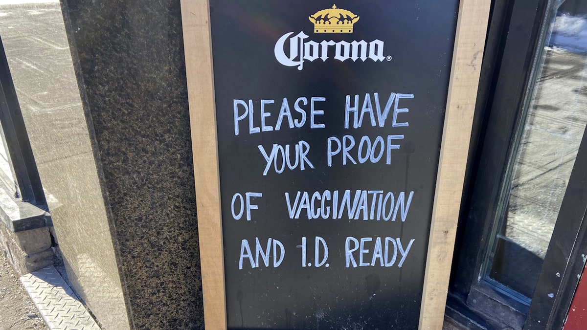 A sign outside a restaurant in downtown Ottawa asks for proof of vaccination.