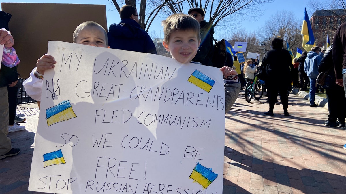 Children hold a sign outside the White House at a pro-Ukraine protest