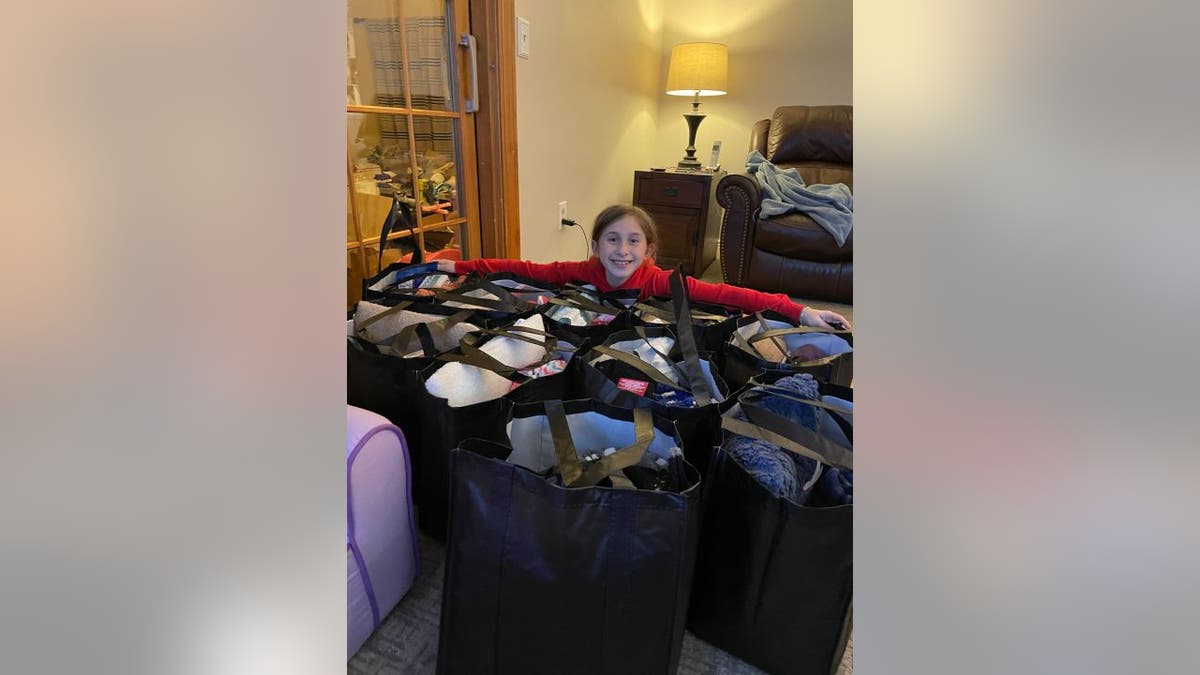 Sophie Enderton poses with chemo comfort bags