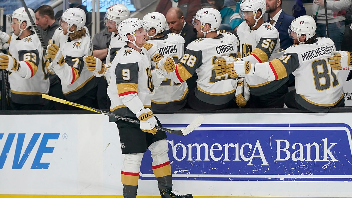 Vegas Golden Knights center Jack Eichel (9) is congratulated by teammates after scoring against the San Jose Sharks during the first period of an NHL hockey game in San Jose, Calif., Sunday, Feb. 20, 2022.