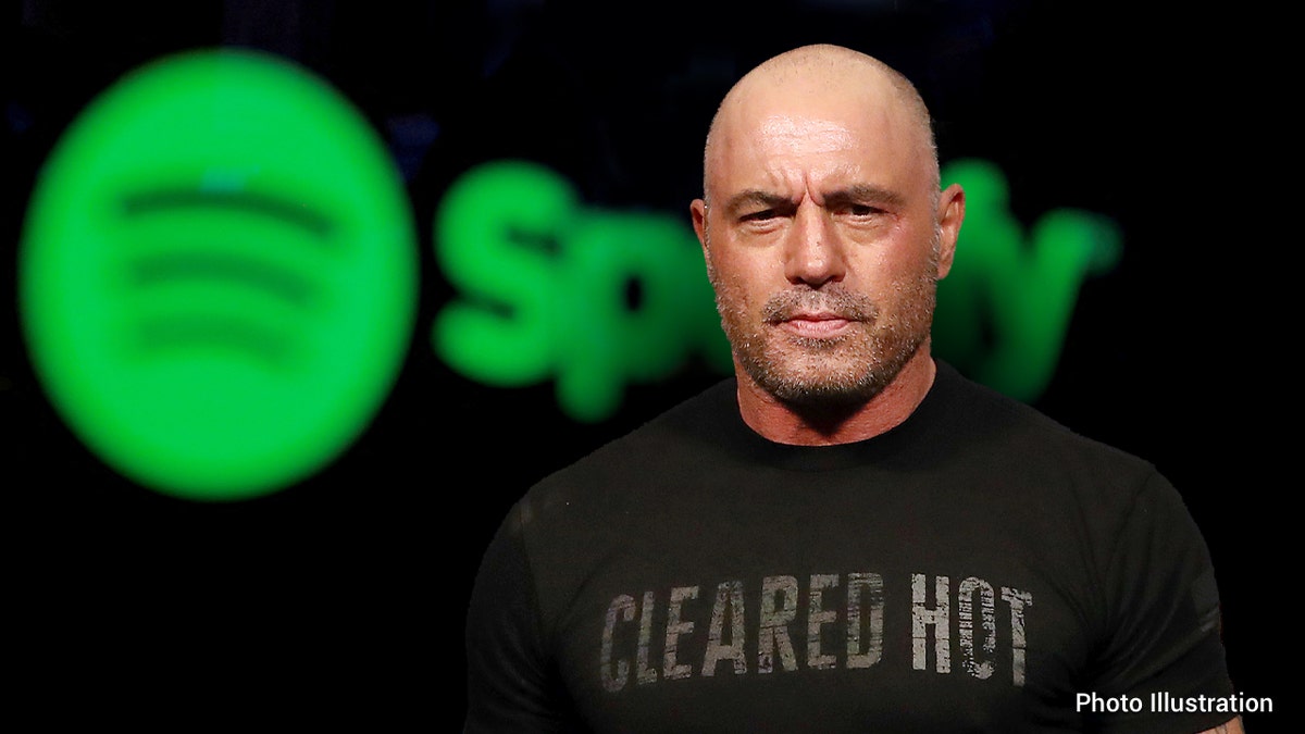 USTON, TEXAS - FEBRUARY 07: Joe Rogan during the UFC 247 ceremonial weigh-in at Toyota Center on February 07, 2020 in Houston, Texas. ?____ FILE PHOTO: A trader is reflected in a computer screen displaying the Spotify brand before the company begins selling as a direct listing on the floor of the New York Stock Exchange in New York, U.S., April 3, 2018.?