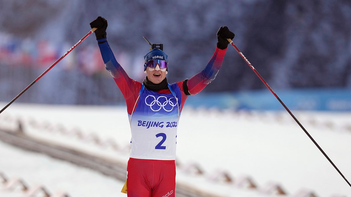 Johannes Thingnes Boe of Norway crosses the finish line in the men's 15-kilometer mass start biathlon at the 2022 Winter Olympics, Friday, Feb. 18, 2022, in Zhangjiakou, China.