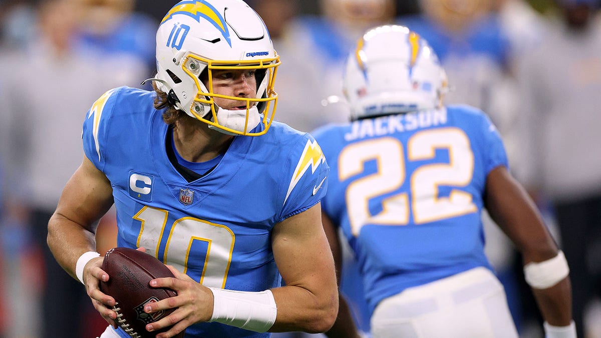 Justin Herbert of the Los Angeles Chargers looks to pass during a 34-28 loss to the Kansas City Chiefs at SoFi Stadium on Dec. 16, 2021 in Inglewood, California.