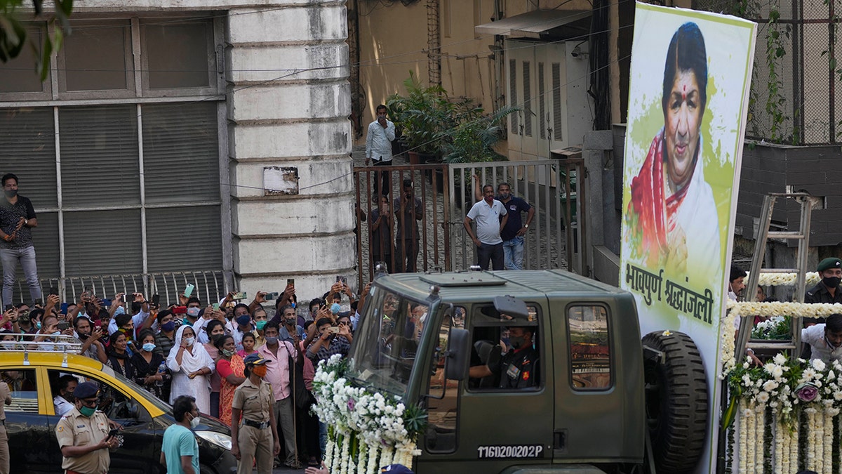 The body of Lata Mangeshkar, is taken for funeral procession outside her house in Mumbai, India, Sunday, Feb.6, 2022. The legendary Indian singer with a prolific, groundbreaking catalog and a voice recognized by a billion people in South Asia, died Sunday morning of multiple organ failure. She was 92.