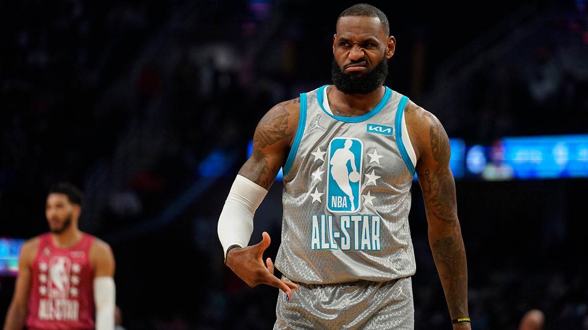 The Los Angeles Lakers' LeBron James reacts to celebrities in the front row as he plays in the first half of the NBA All-Star basketball game, Sunday, Feb. 20, 2022, in Cleveland.