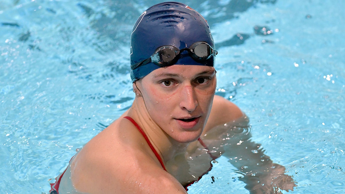 Penn transgender swimmer Lia Thomas speaks to her coach after winning the 500 meter freestyle during an NCAA college swimming meet with Harvard Saturday, Jan. 22, 2022, at Harvard University in Cambridge, Mass. 