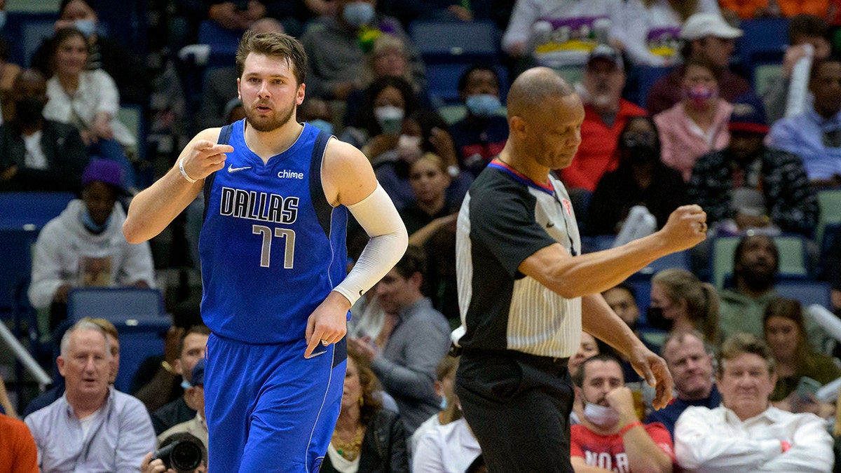 Dallas Mavericks guard Luka Doncic (77) points to the crowd after a score during the second half of an NBA basketball game against the New Orleans Pelicans in New Orleans, Thursday, Feb. 17, 2022. 