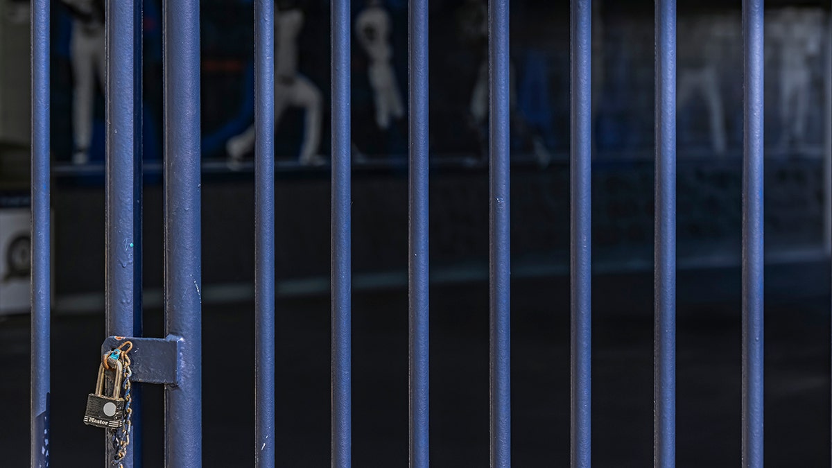A padlock keeps the gate closed at the New York Yankees spring training complex at George M. Steinbrenner Field, Wednesday, Feb. 16, 2022, in Tampa, Fla. The usual spring training buzz is missing because of a lockout that’s now extended to 77 days and become the second-longest work stoppage in baseball history.