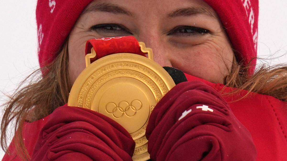 Michelle Gisin of Switzerland celebrates winning the gold medal during the medal ceremony for the women's combined at the 2022 Winter Olympics, Thursday, Feb. 17, 2022, in the Yanqing district of Beijing.?