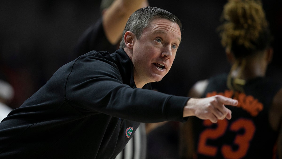 Florida head coach Mike White hollers at the team during the first half of an NCAA college basketball game against Auburn Saturday, Feb. 19, 2022, in Gainesville, Fla. 