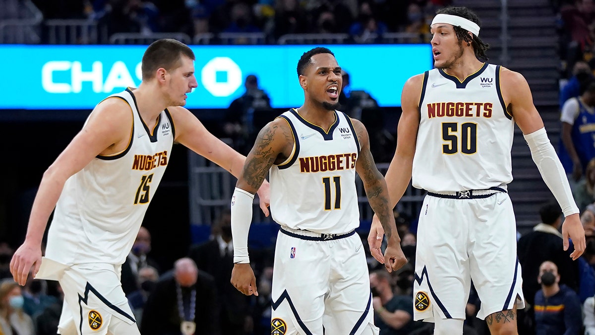 Denver Nuggets guard Monte Morris (11) is congratulated by center Nikola Jokic (15) and forward Aaron Gordon (50) after shooting a 3-point basket against the Golden State Warriors during the second half of an NBA basketball game in San Francisco, Wednesday, Feb. 16, 2022.
