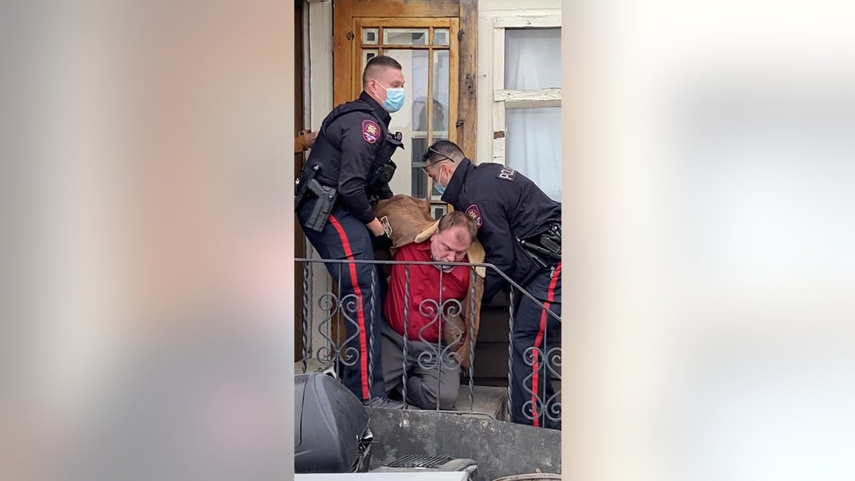 Artur Pawlowski being arrested at his home