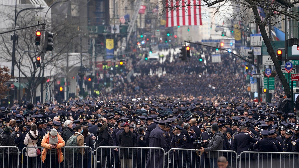 New York Police officers gather along Fifth Avenue outside St. Patrick's Cathedral for Officer Wilbert Mora's funeral, Wednesday, Feb. 2, 2022, in New York.