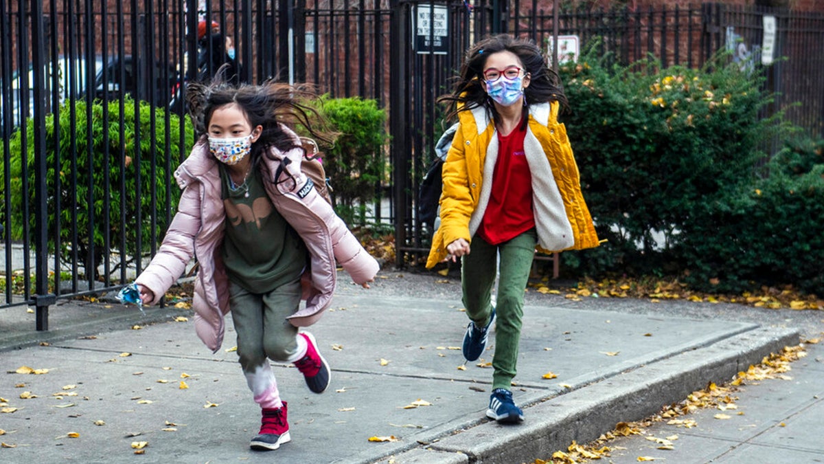 FILE: Students wearing masks leave the New Explorations into Science, Technology and Math (NEST+m) school in the Lower East Side neighborhood of Manhattan, Dec. 21, 2021, in New York. 