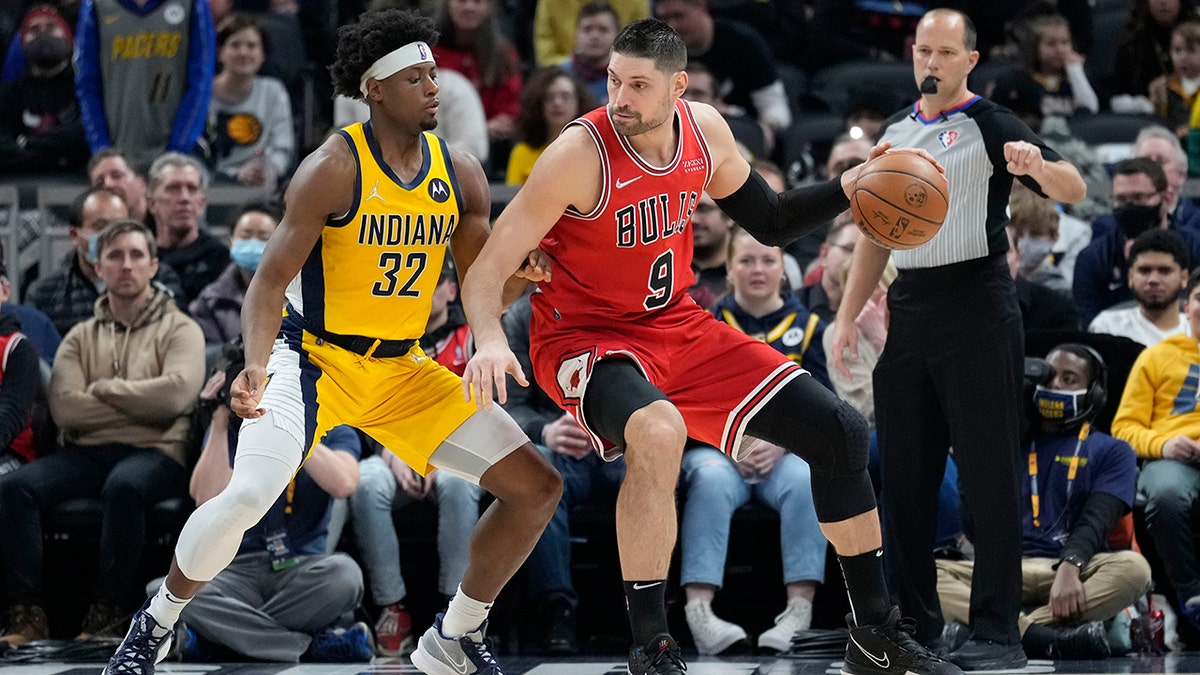 Chicago Bulls center Nikola Vucevic (9) moves to the basket in front of Indiana Pacers guard Terry Taylor (32) during the first half of an NBA basketball game in Indianapolis, Friday, Feb. 4, 2022.