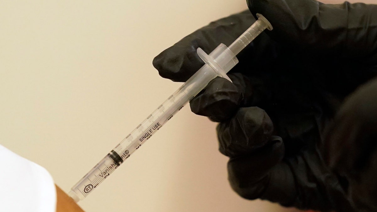 A person is injected with her second dose of the Pfizer COVID-19 vaccine at a Dallas County Health and Human Services vaccination site in Dallas, Thursday, Aug. 26, 2021. Federal health regulators on Friday, Feb. 11, 2022 delayed next week’s public meeting to review Pfizer’s COVID-19 vaccine for children under 5, saying they want to see more data. (AP Photo/LM Otero, File)