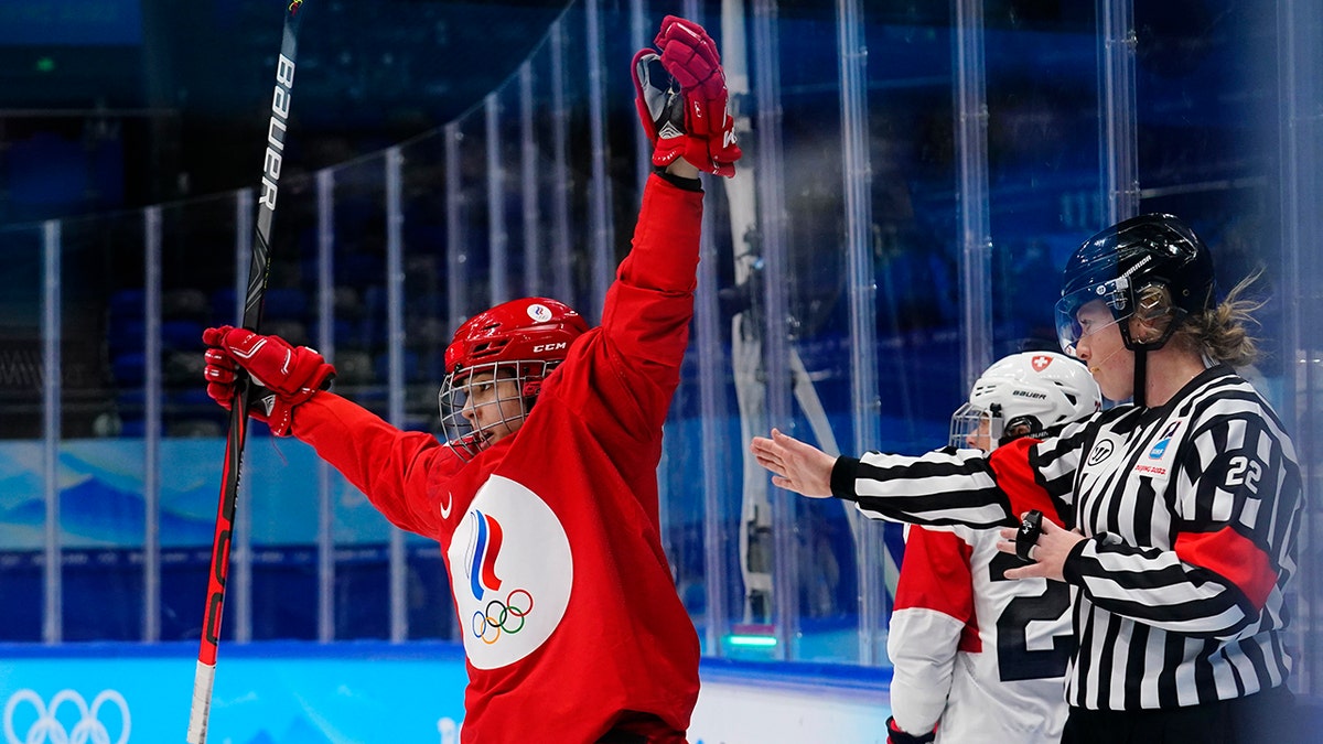 Russian Olympic Committee's Polina Bolgareva, left, celebrates after scoring a goal against Switzerland during a preliminary round women's hockey game at the 2022 Winter Olympics, Friday, Feb. 4, 2022, in Beijing.