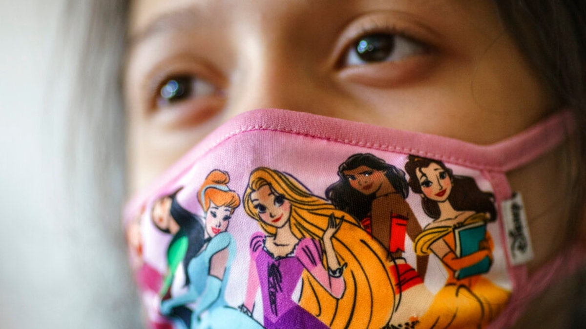 A student wears a mask during class at Raices Dual Language Academy, a public school in Central Falls, R.I., Wednesday, Feb. 9, 2022.