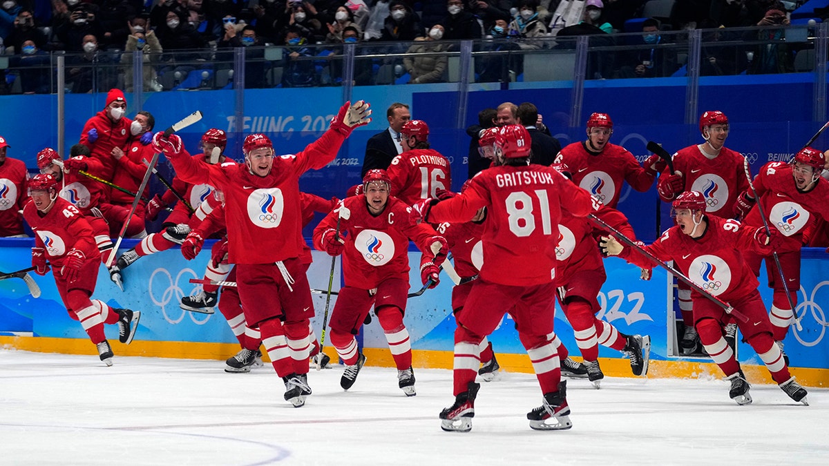 The Russian Olympic Committee celebrates the winning goal during a shootout by Arseni Gritsyuk (81) in a men's semifinal hockey game against Sweden at the 2022 Winter Olympics, Friday, Feb. 18, 2022, in Beijing. 