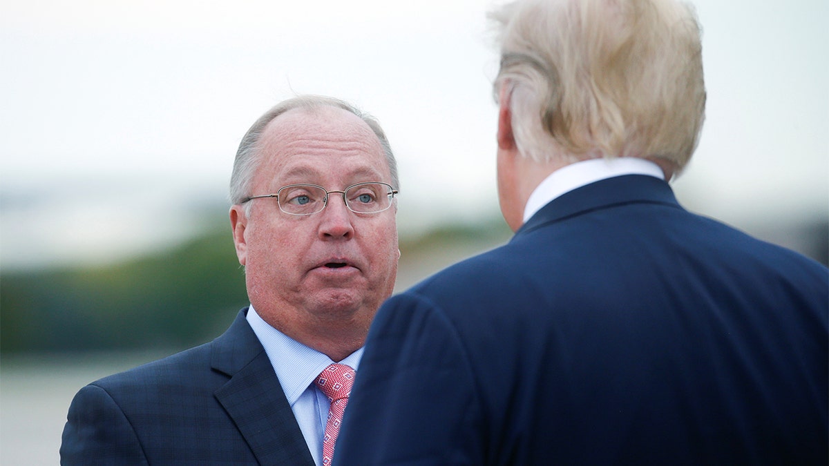 President Trump talks with Minnesota 1st Congressional District Republican nominee Jim Hagedorn as the president arrives at Minneapolis – Saint Paul International Airport for nearby fundraising and campaigning in Minneapolis, Minnesota, Oct. 4, 2018.