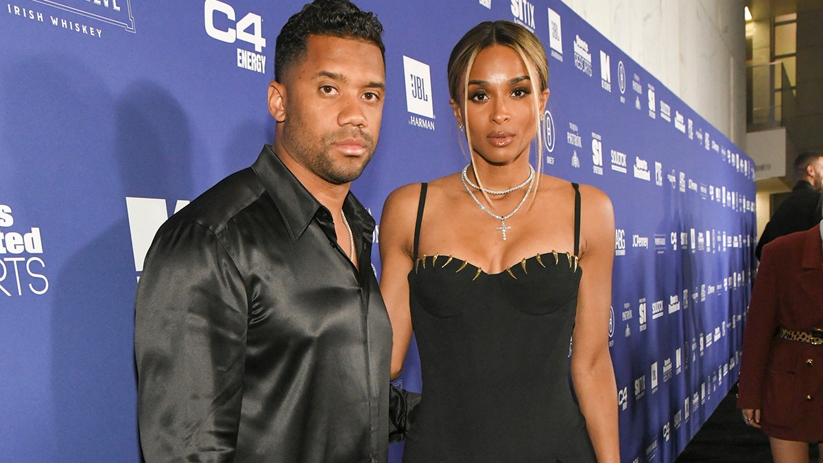 Ciara and Russell Wilson pose on a red carpet