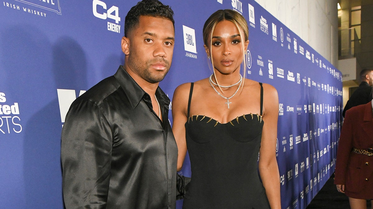 Russell Wilson and Ciara kept their looks simple, rocking a matching black shirt and dress combination.